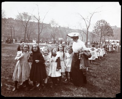 Children in a long line being led by a woman on Arbor Day at Tompkins Square Park, New York, 1904 by Byron Company